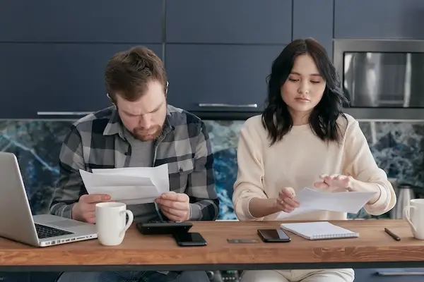 average monthly electric bill with solar panels man checking document